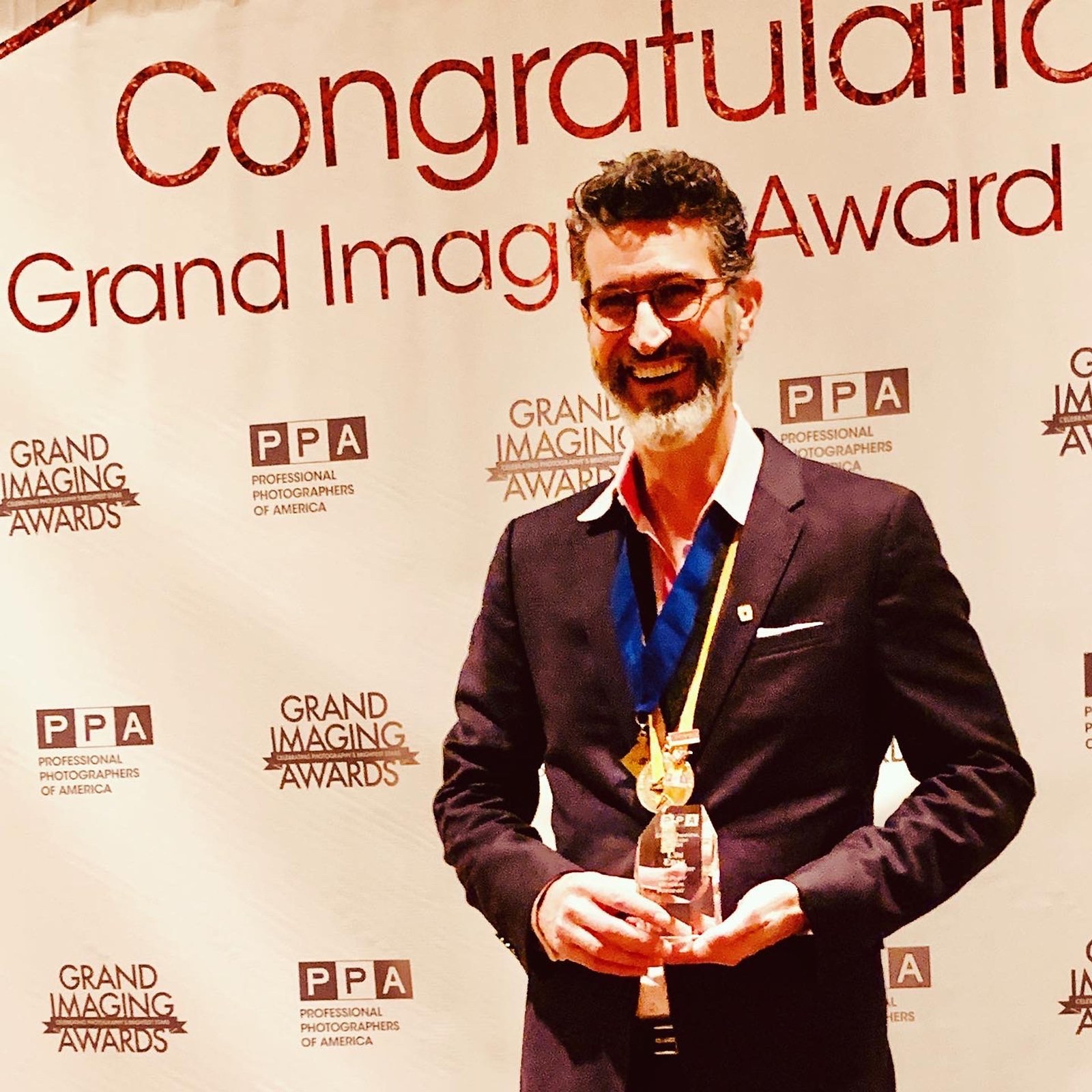 Udi Edni holding the Grand Imaging Award trophy at Imaging USA 2020