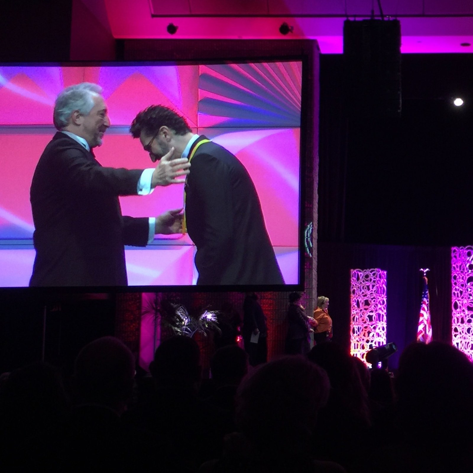 Udi Edni receiving the PPA Master Photographer degree on stage