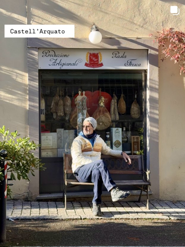 Udi on a bench outside a pasta shop, Castell'Arquato