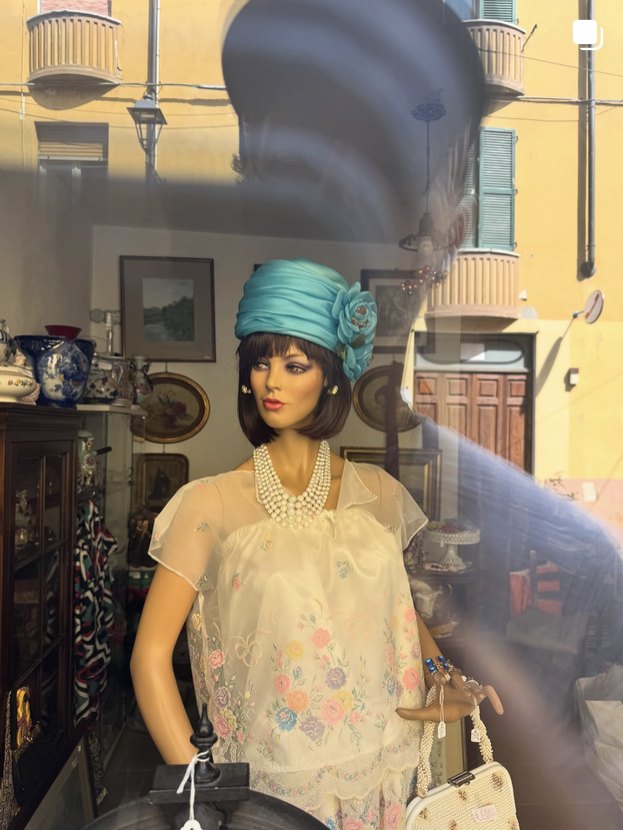Vintage mannequin in a shop window with reflections