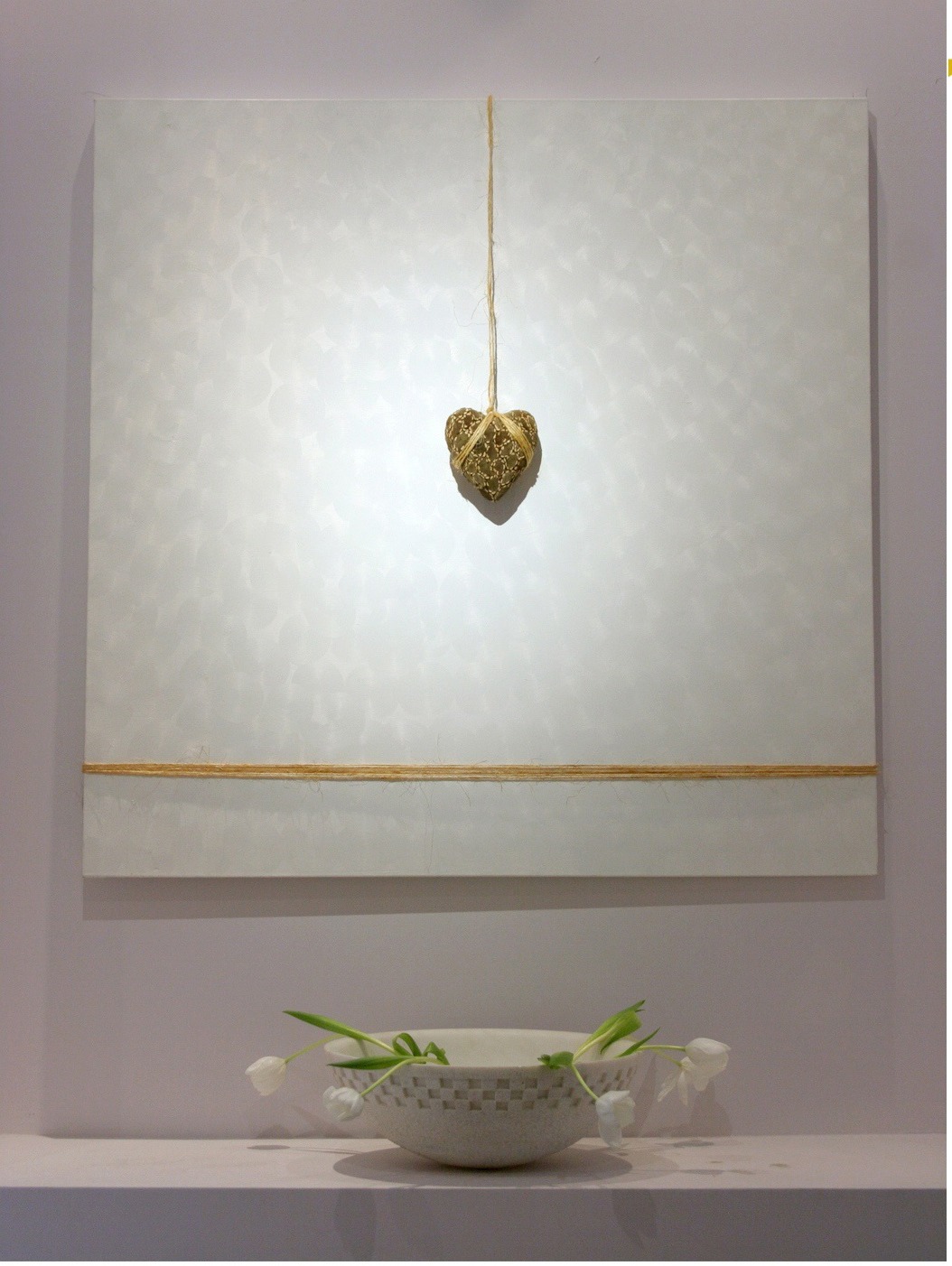 White oil painting with a hanging golden heart
